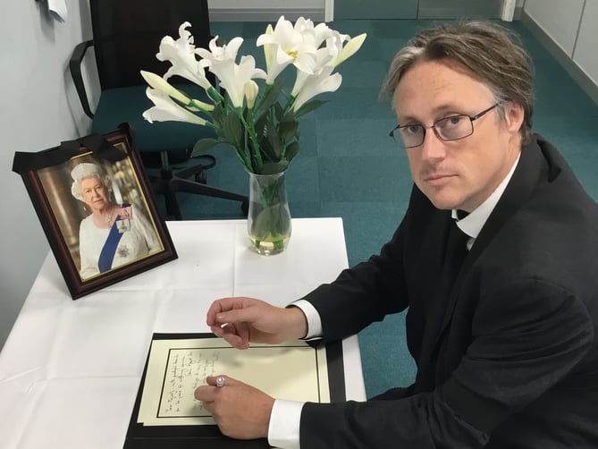 Cllr Richard Millard, East Hampshire District Council leader, signs the book of condolence held at Penns Place, Petersfield