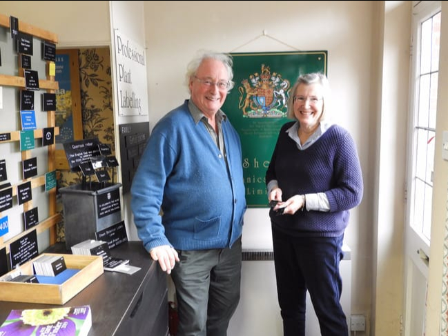 Christopher and Carmen Ashton-Jones by the coat of arms