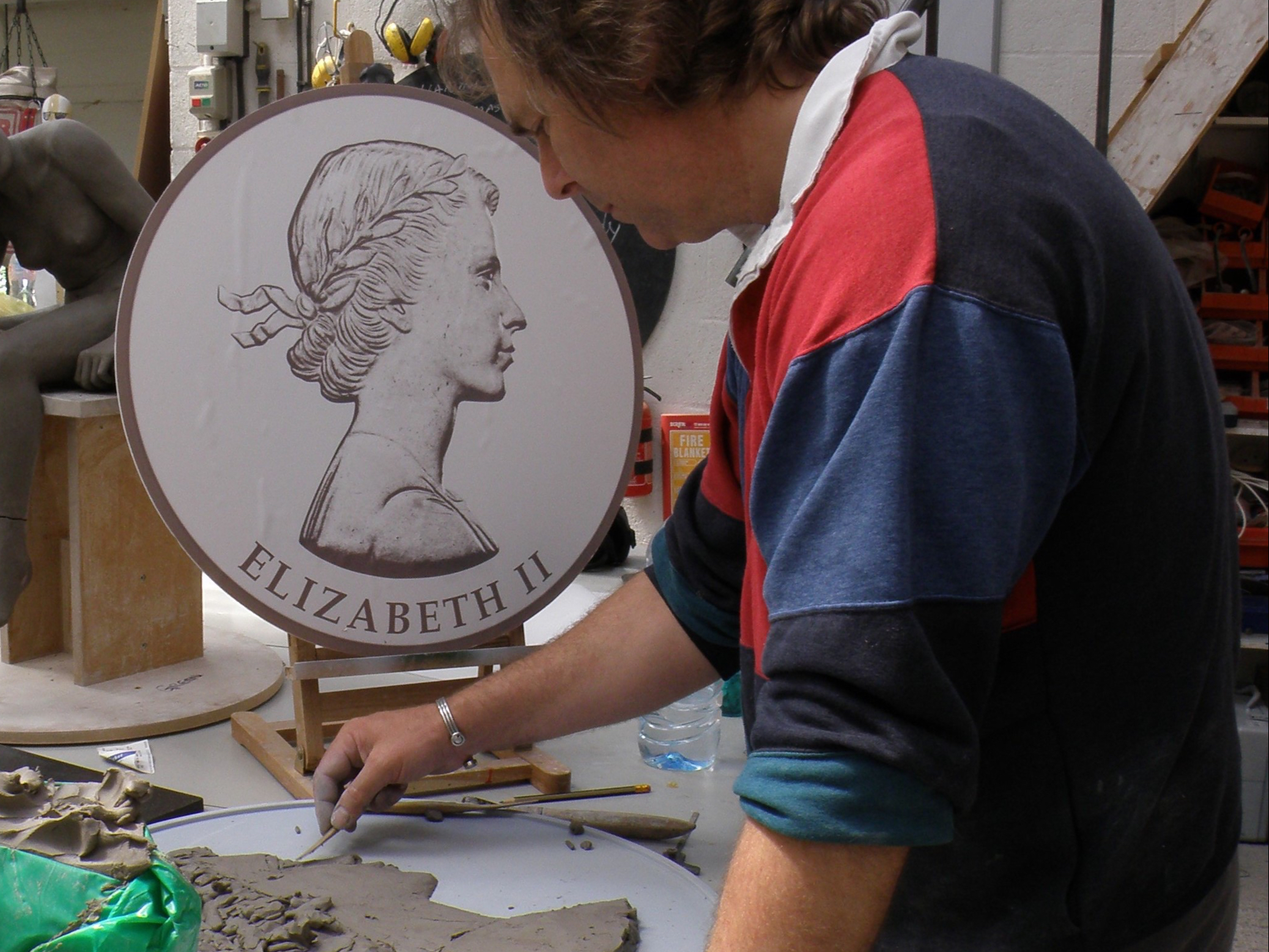 Andrew Sinclair working in clay to produce the Queen’s portrait for The Royal Box at Ascot Racecourse.