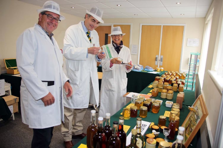 Stewards Ross Hanley and Rosemarie Lane with Judge Peter Lewis judging this years honey. Picture by Paul Hamlyn.
