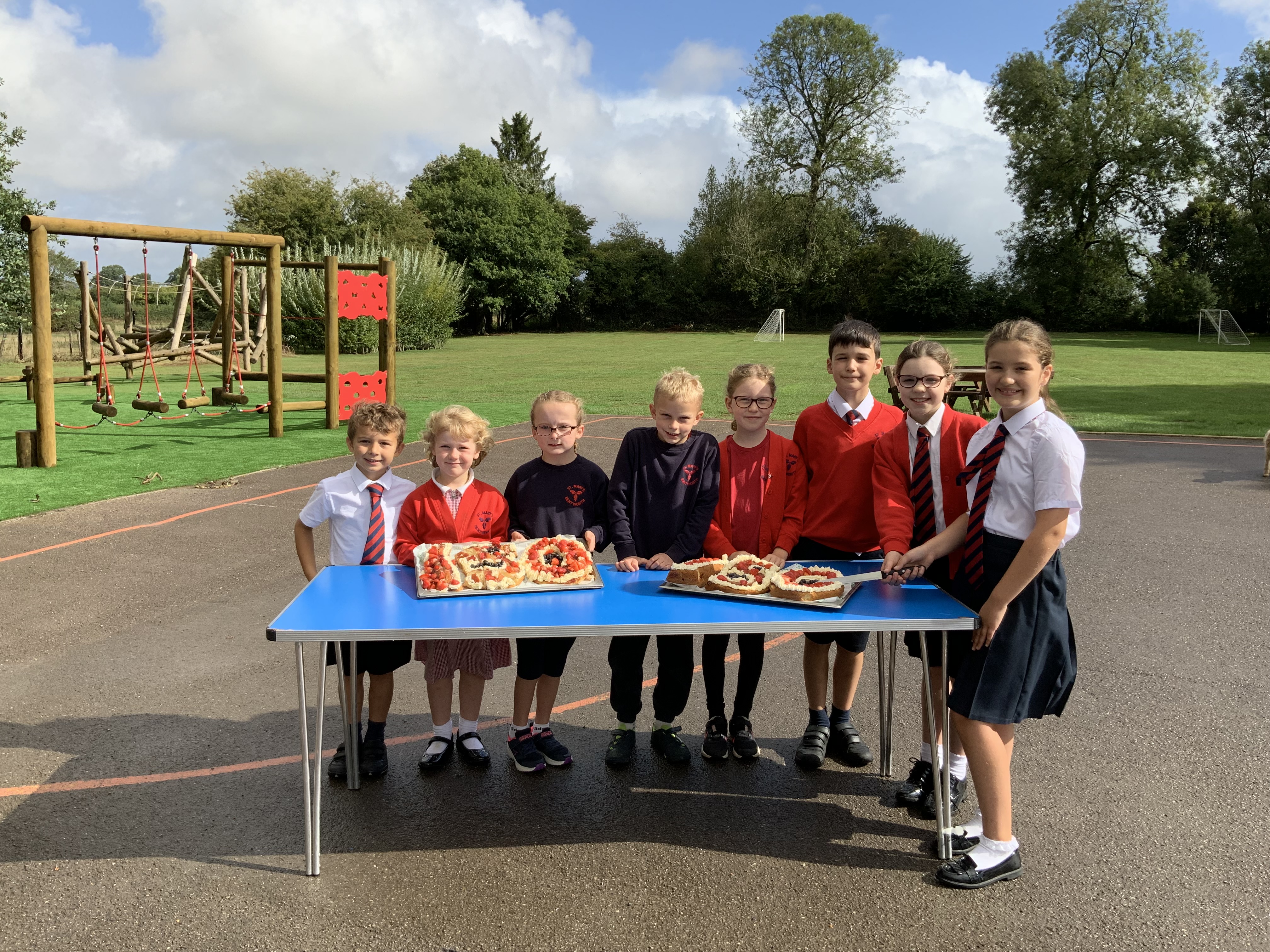 <p>Some of the St Mary’s Bentworth pupils with the ‘150’ cakes</p>