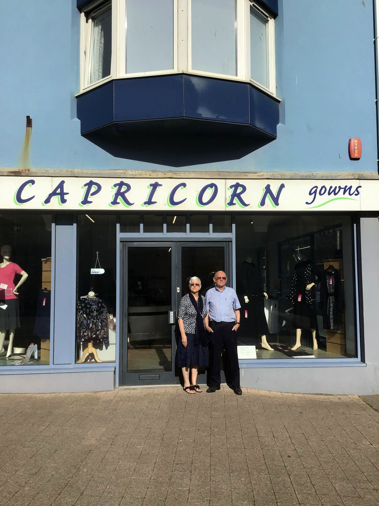 Husband and wife retail team, Eira and Michael Nelson outside the Capricorn Gowns. The business has been in the Cambrian News many times over the last 44 years as these cuttings from the paper show