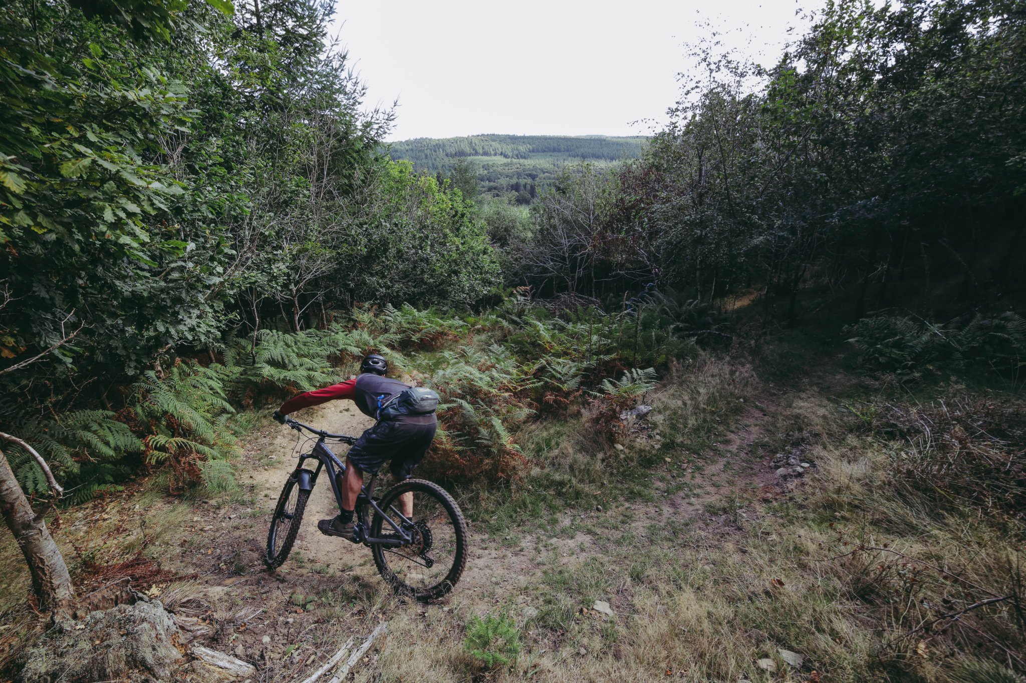 A group of volunteers at a womens’ trail dig and below, a rider takes to the trail on its opening day