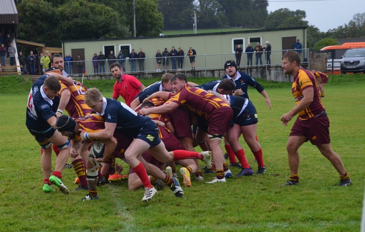 Above and right, Okehampton first XV endured a tough day at the office in poor conditions but their grit and determination pleased captain Dan Fogerty