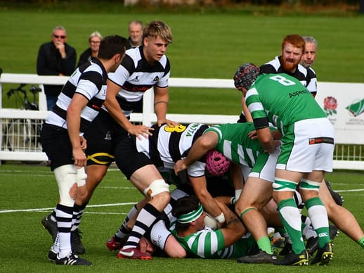 Oscar Henderson, supported by Fin Anderson, gets his hands on the ball