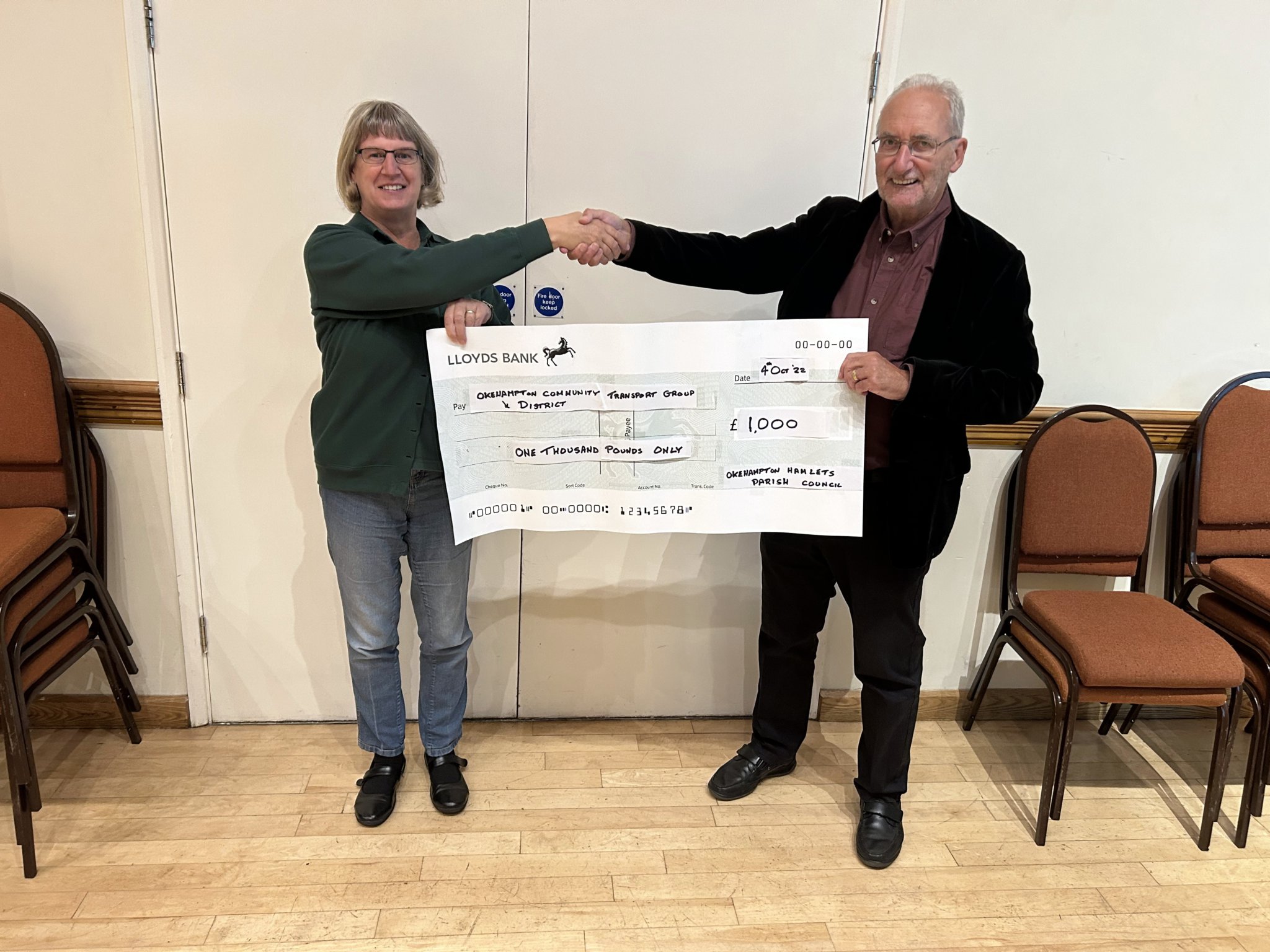 Above: Chairman of Okehampton Hamlets Parish Council Brian Wood (right) presents Liz Westlake from ODCTG with a cheque for £1,000. Below: Cllr Wood presents Ian Brooker from the Dartmoor National Park Authority with a cheque for £500.