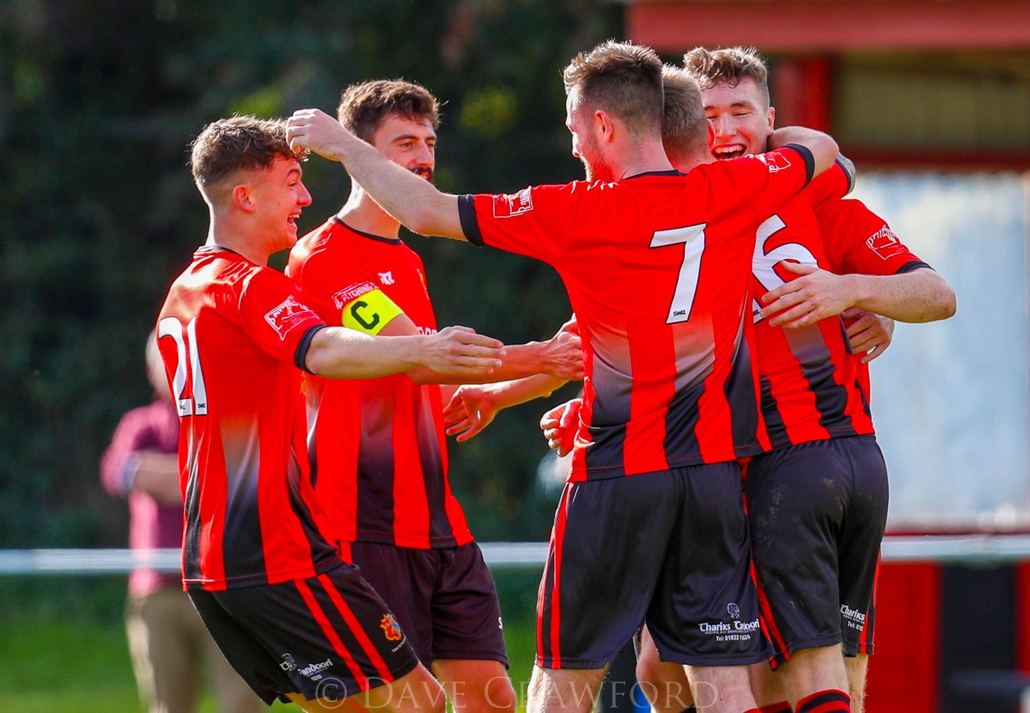 MAIN: Tavistock celebrate scoring against Melksham. INSET: A header is hotly contested. Photographs by Dave Crawford.