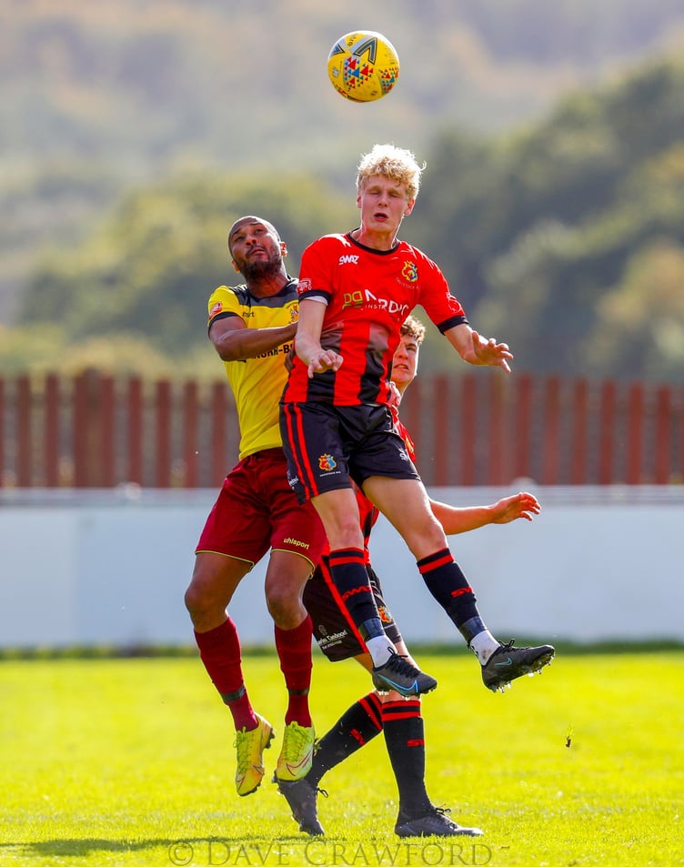 MAIN: Tavistock celebrate scoring against Melksham. INSET: A header is hotly contested. Photographs by Dave Crawford.