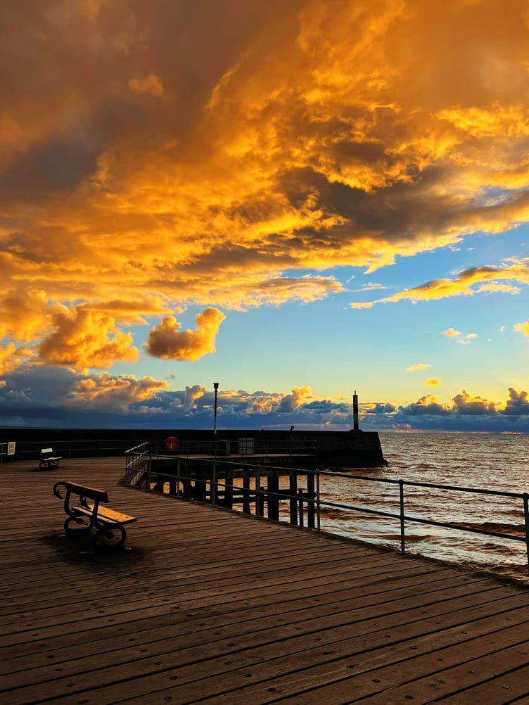 A dramatic sky over Aberystwyth promenade as the sun sets, taken by Jane Wemyss-Owen