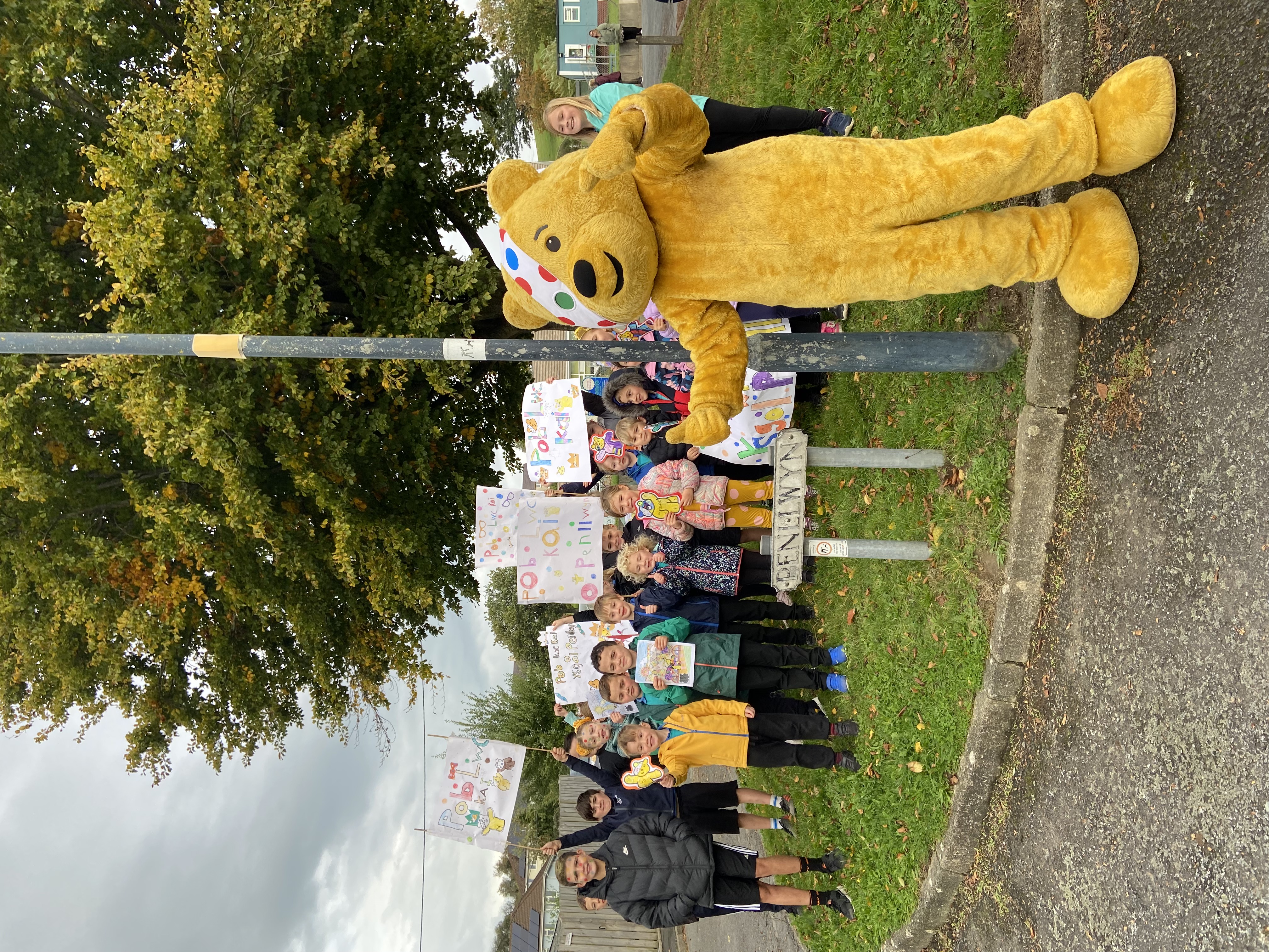 Pudsey with pupils from Ysgol Penllwyn in Capel Bangor cheering Kai on