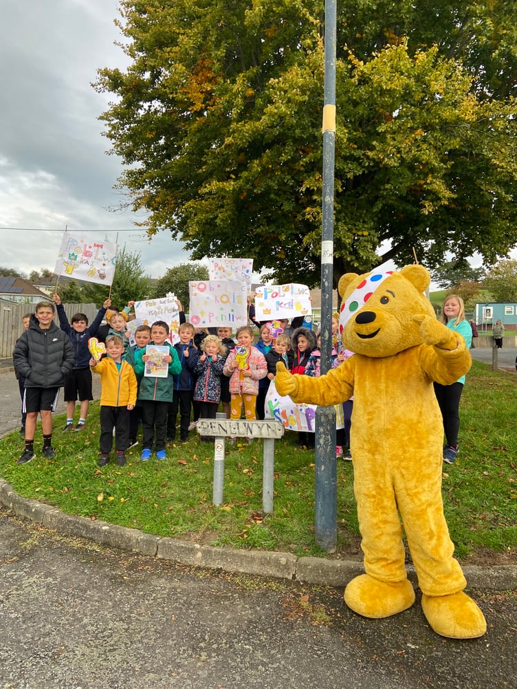 Pudsey with pupils from Ysgol Penllwyn in Capel Bangor cheering Kai on