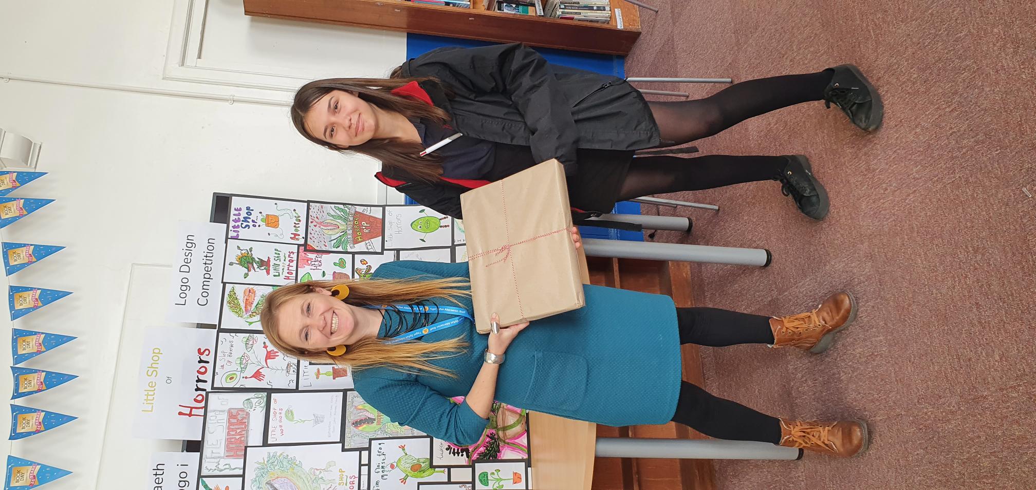 Rhian Graham, of Aeron Stars, with competition winner Roxanne Smith of Ysgol Gyfun Aberaeron. Pictured right is Roxanne’s winning design