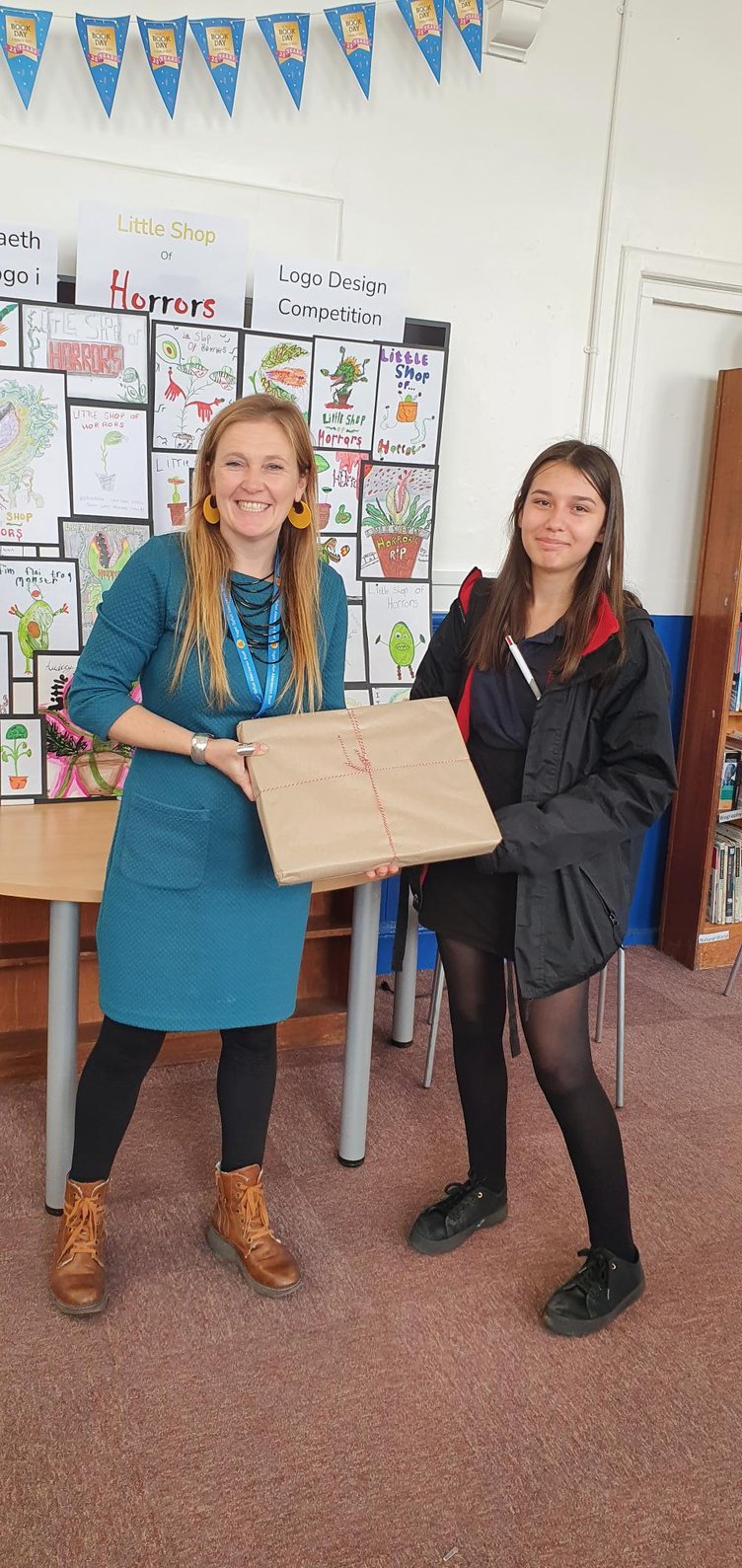 Rhian Graham, of Aeron Stars, with competition winner Roxanne Smith of Ysgol Gyfun Aberaeron. Pictured right is Roxanne’s winning design