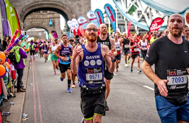 Gavin Worrell during the marathon and (inset) crossing the finishing line