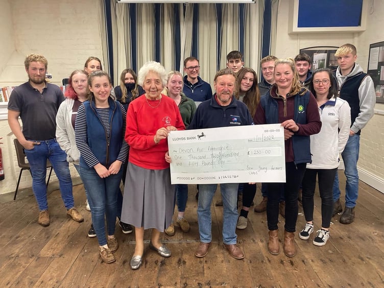 Gill Gunn and John Groves, local representatives, receiving the cheque for Devon Air Ambulance.