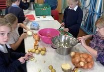 School children’s soup kitchen feeds village