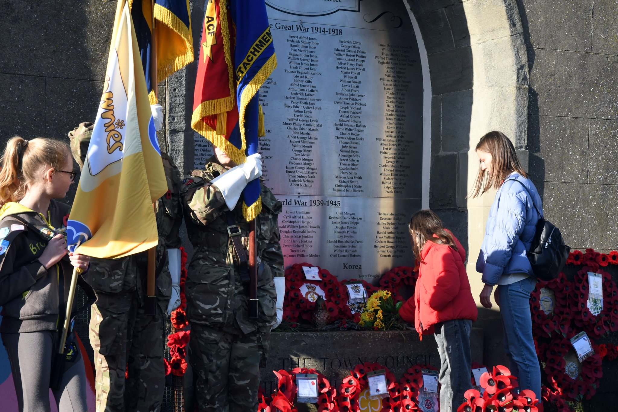 Nika Vasylenko and her mother Yuliia from the Ukrainian capital Kyiv place a posy of sunflowers on the war memorial in Coleford.