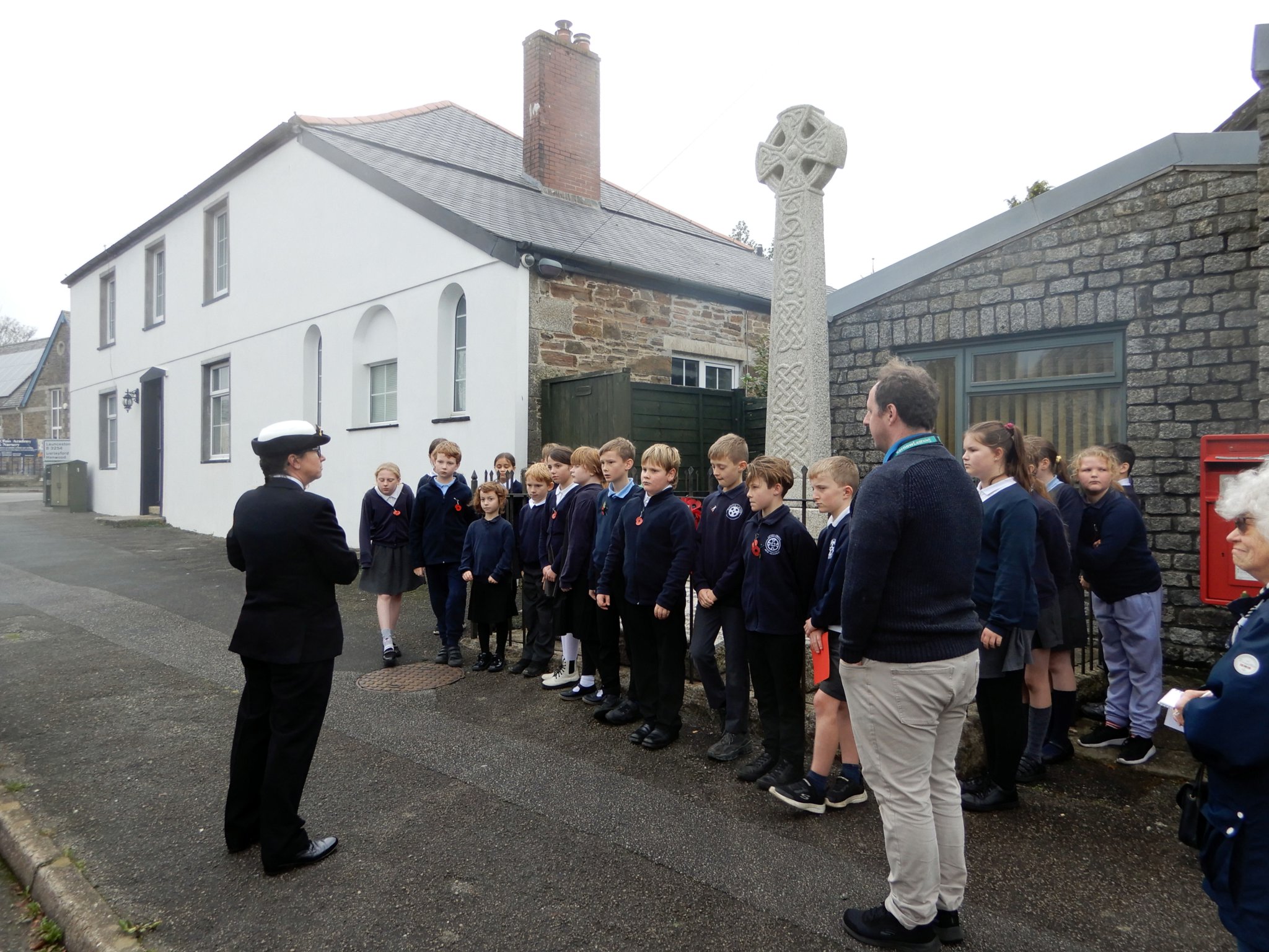Lt Cdr Penelope Thompson addressing the pupils of Upton Cross Ace Academy following the wreath laying