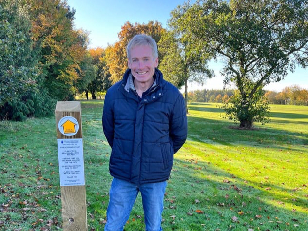 Gloucestershire Public Rights of Way Officer Jeff Wheeler with a new way marker on Bells golf course
