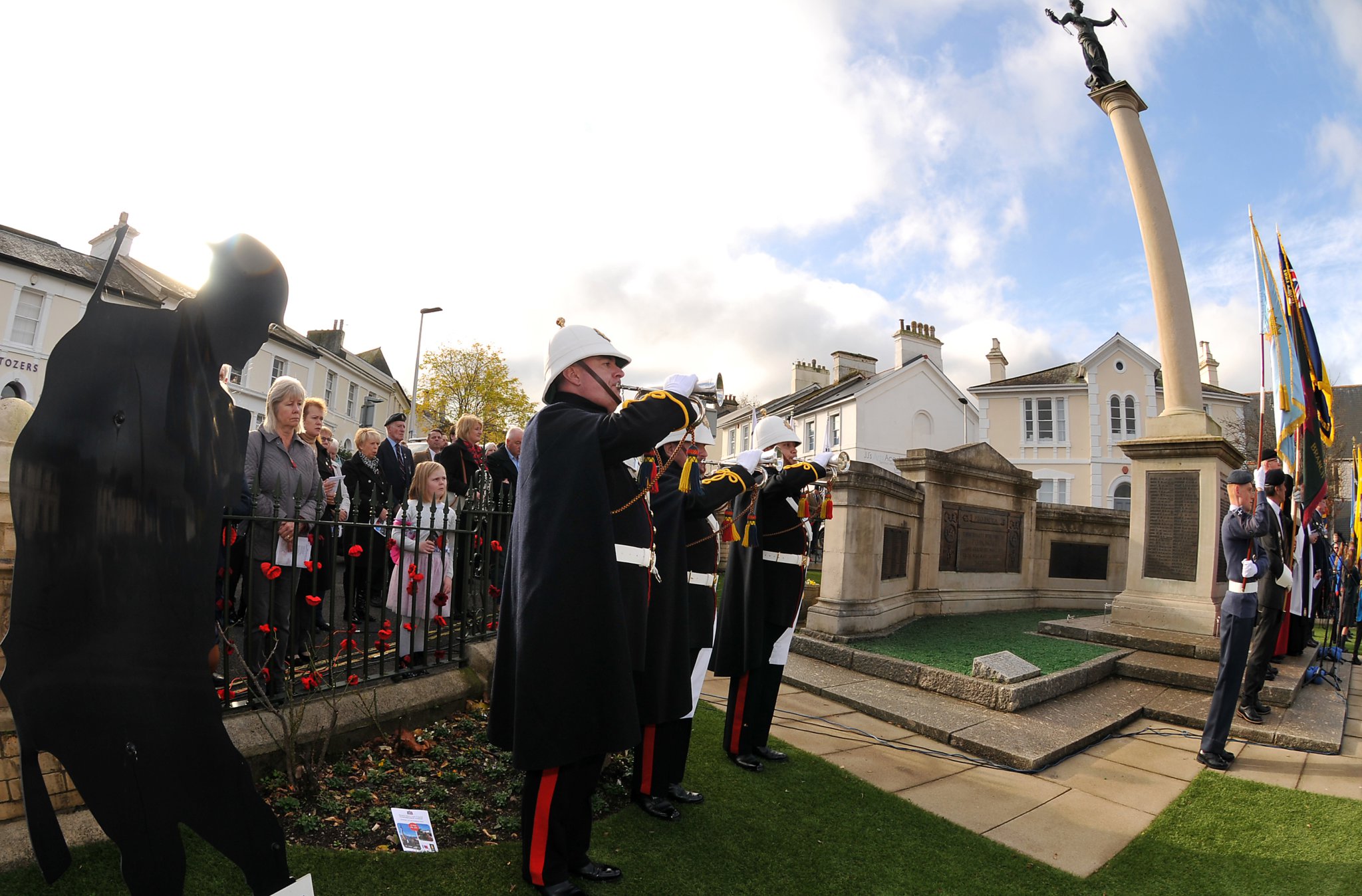 Plymouth Maritime Corps of Drums leads the parade up Queen Street to the war memorial