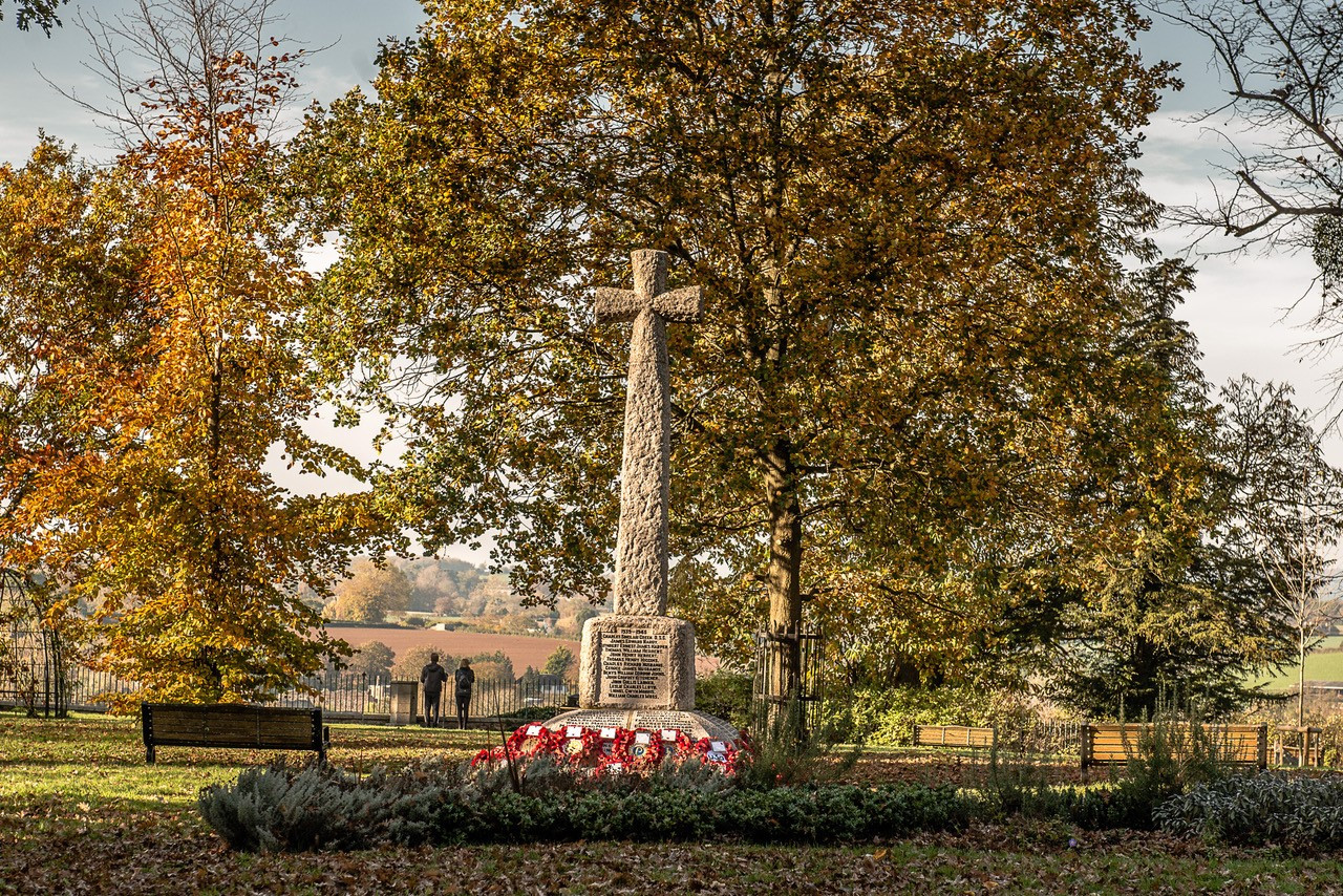 War Memorial, The Prospect (left); Paul Deneen OBE JP DL, Mayor Cllr Ed O’Driscoll, Rector and Chair RBL Mr Graham Aplin, addresses those attending Armistice (centre); standard bearers (right)