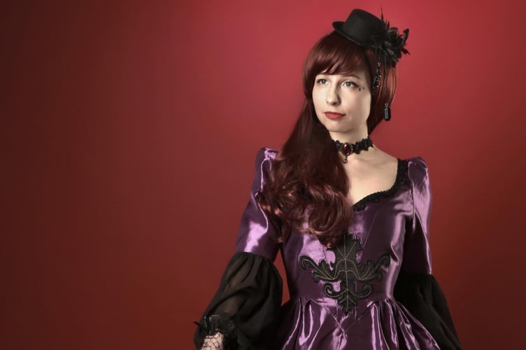 Woman in Victorian costume.