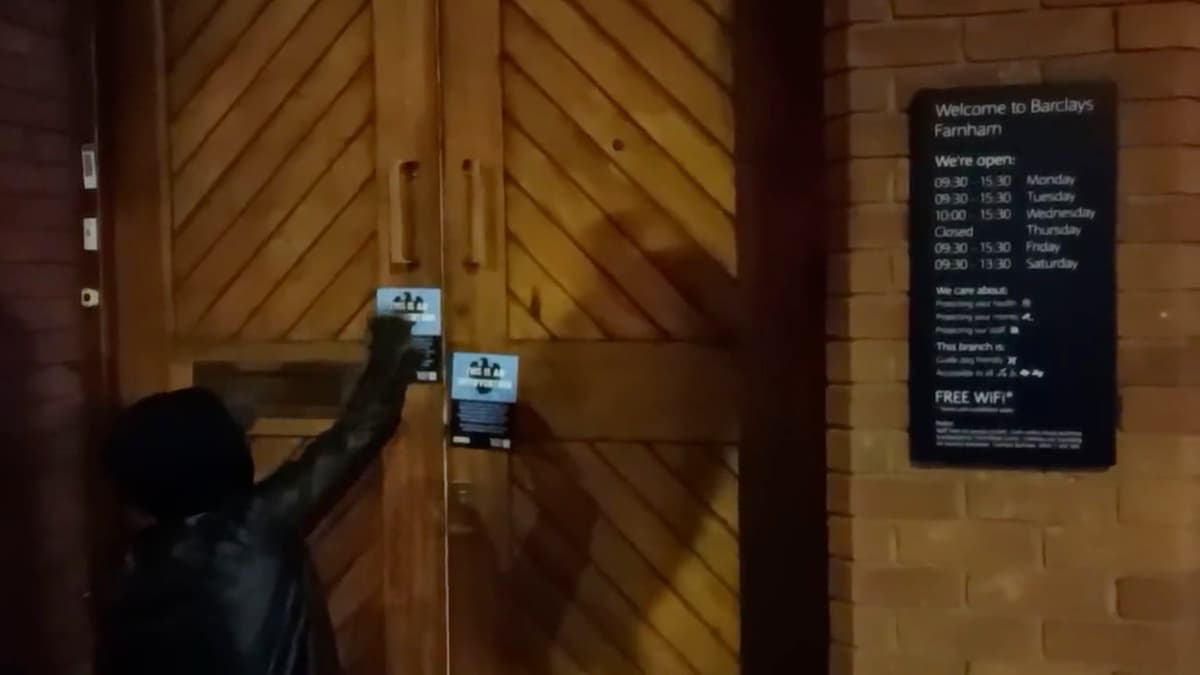 Extinction Rebellion protester glues shut door of Farnham’s Barclays