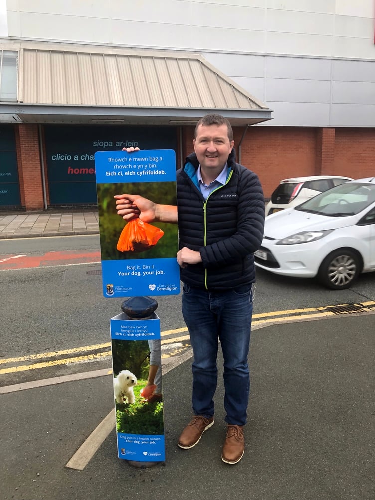 Cllr Catrin M S Davies and Cllr Keith Henson with the new posters