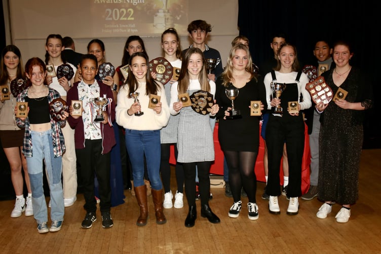 ABOVE: Bob Chapman receives a framed Tavistock Athletics Club vest to mark his honorary lifetime membership of the club. BELOW: Young athletes show their silverware from a successful club awards night.
