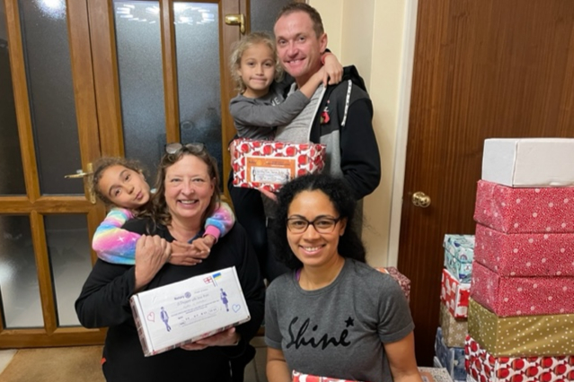 <p>Lisa Hillan, left, Igor and Biola Ameri and their daughters pack the Christmas boxes heading to Ukraine</p>