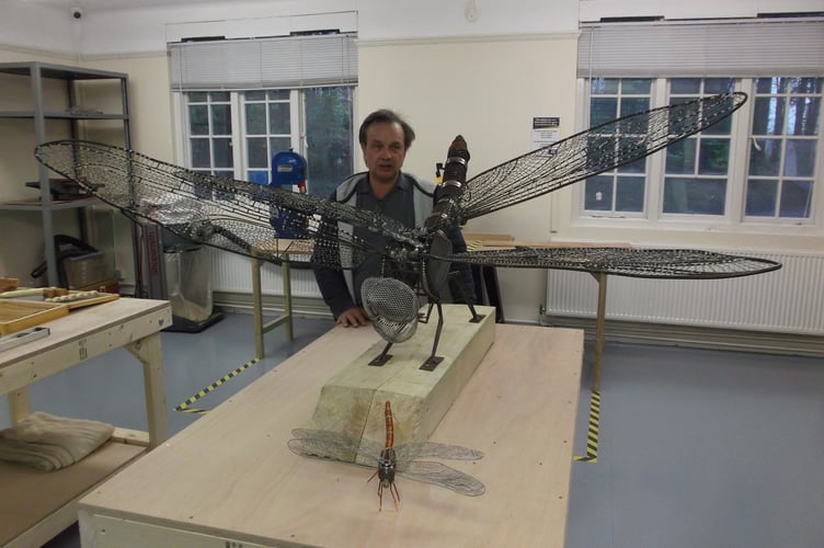 Cllr Roger Russell with a wire sculpture dragonfly he made, SiGNAL Bordon, April 4th 2019.