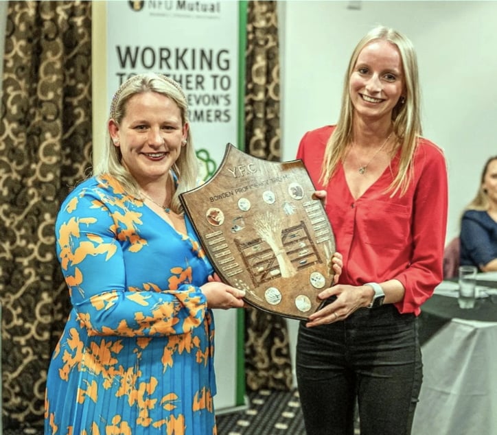 Last years Bradworthy Secretary, Karen Cawsey, collecting the Bowden Shield for Outstanding Individual Contribution in the Year from outgoing Devon County Chairman Rosie Bennett