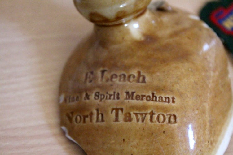The top of a stoneware bottle listing E Leach, Wine and Spirit Merchant, North Tawton. SR 6469