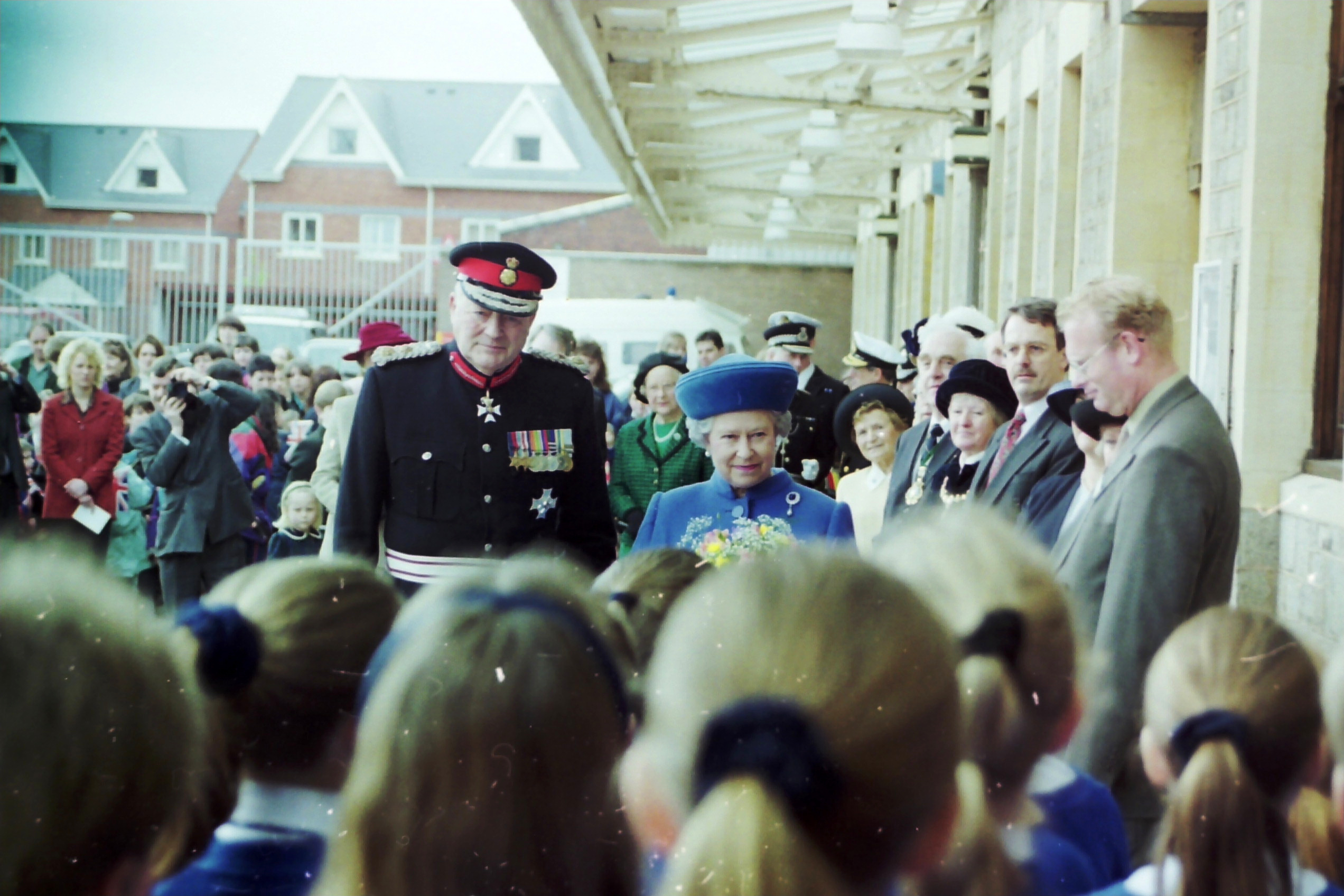 The Queen and Lord Lieutenant of Devon listening to children singing St David’s Station on March 27, 1998.