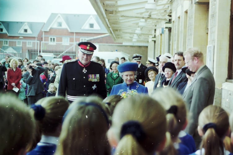 The Queen and Lord Lieutenant of Devon listening to children singing St David’s Station on March 27, 1998.