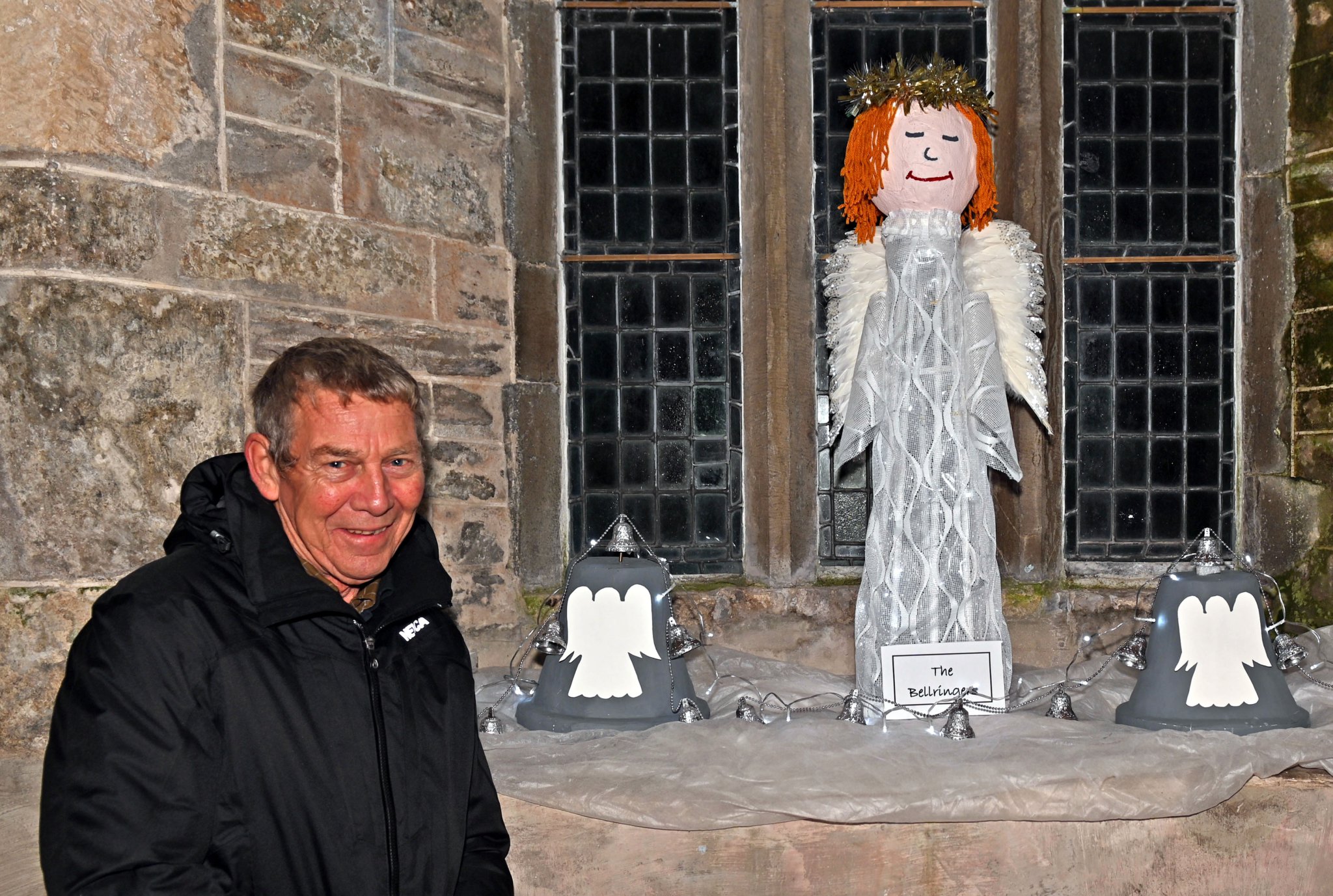 Paul Burden (captain of the tower) proudly shows off the St Teath Bell ringers window display in the church created by Jeannette Sweet