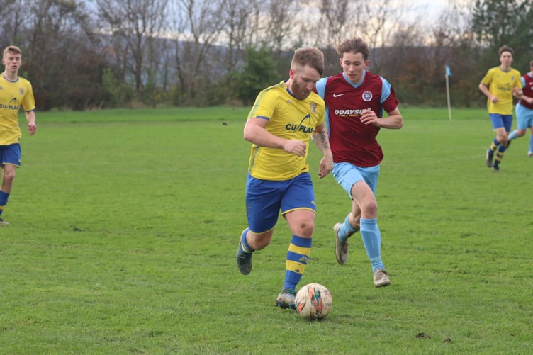 Onchan’s George Butler (left) attempts to escape the attentions of Union Mills’ Tyler Hughes during Saturday’s Canada Life Premier League clash at Garey Mooar. The latter played a starring role for the Millers with a two-goal salvo to help seal a dramatic 5-4 win and earn his place in the latest Team of the Week (Photo: Paul Hatton)