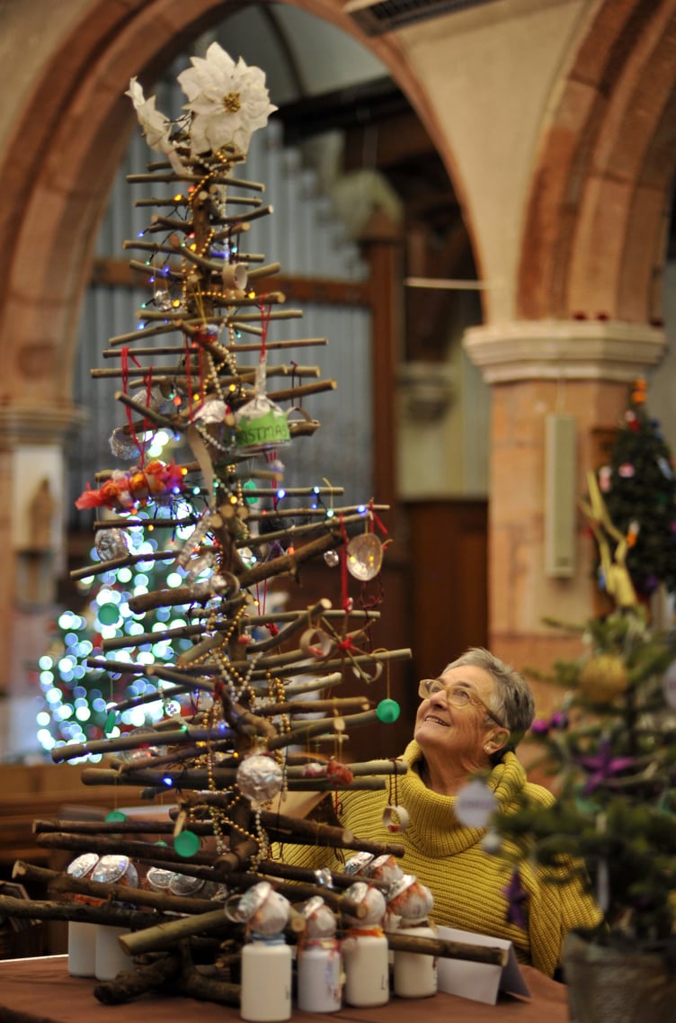 Photo: Steve Pope MDA071222D_SP007
Christmas tree festival at St Mary's Church, Kingskerswell. Jenney Benney admires the parish council's recycled tree