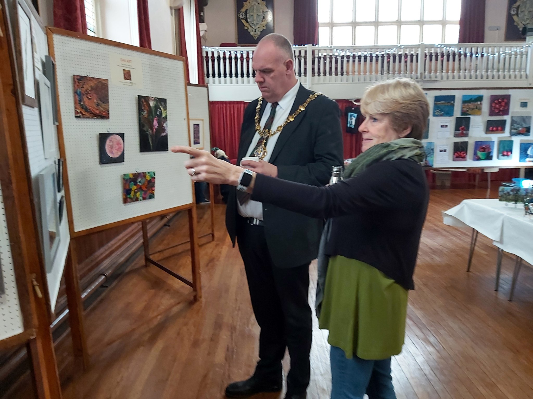 aBOVE: Karen Burden shows her paintings to Liskeard Mayor Cllr Simon Cassidy; Below, mosaic artist Kirsty Freeman with MP for South East Cornwall Sheryll Murray