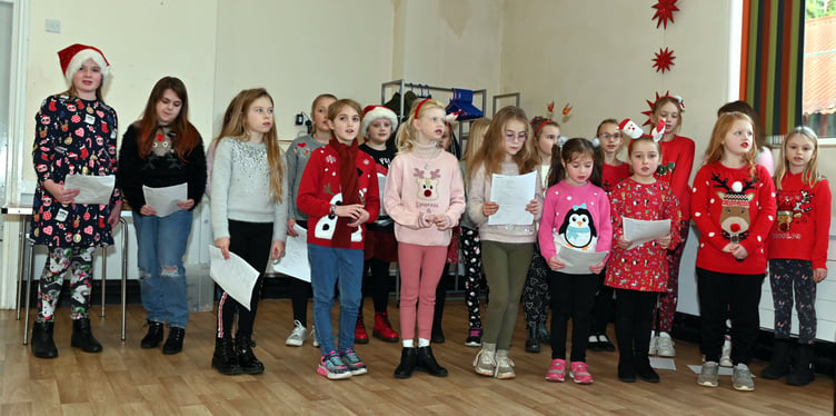 ABOVE: Best friends Stephanie Jasper and Di Pengelly; Left, In fine voice giving their rendition of some Christmas favourites are members of the Camelford Primary School Choir. Pictures: Adrian Jasper