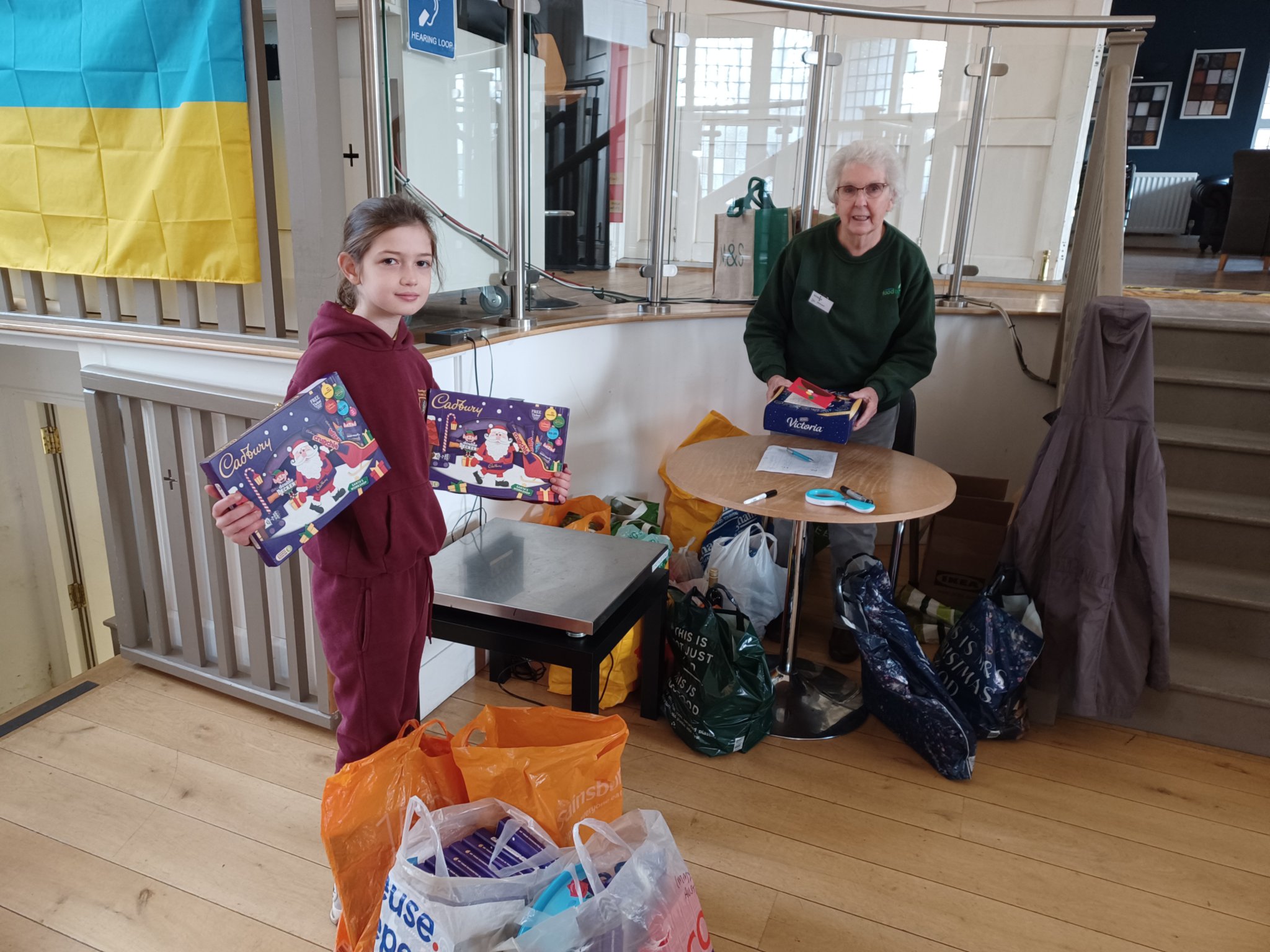 Immy, eight, delivers her Christmas chocolates haul to the food bank