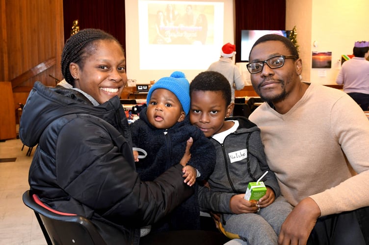 A special event at Cafe Lingo celebrating winter festivals around the world - left to right: Grace Maunze, Nyle Maunze (6 months), NaIshe Maunze (7) and Lewis Maunze