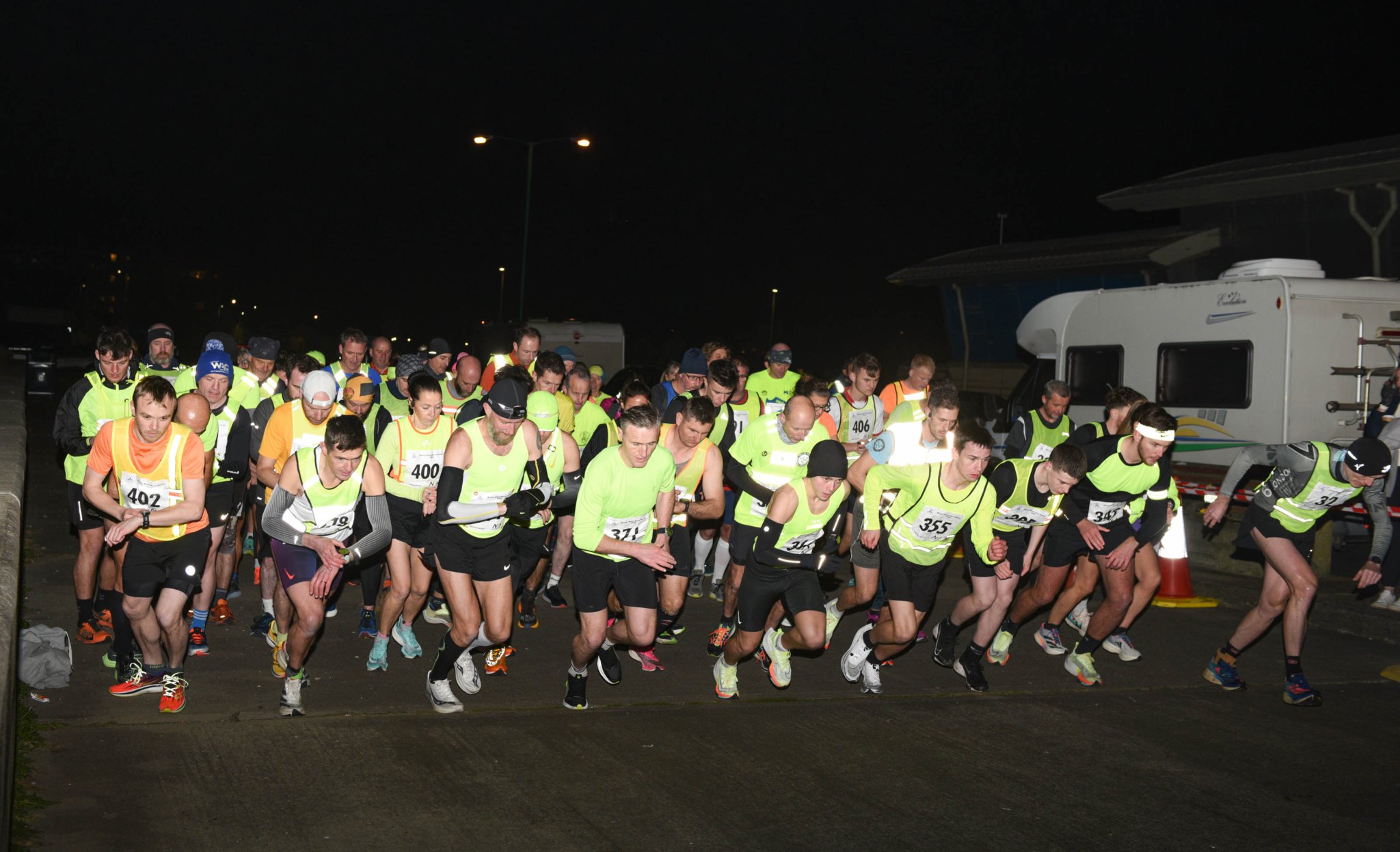 The start of the three-lap 5km road race in Ramsey a week last Tuesday with eventual winner Orran Smith fourth from left (front row) and runner-up Sam Perry fourth from right (Photo: Phil Crowe)