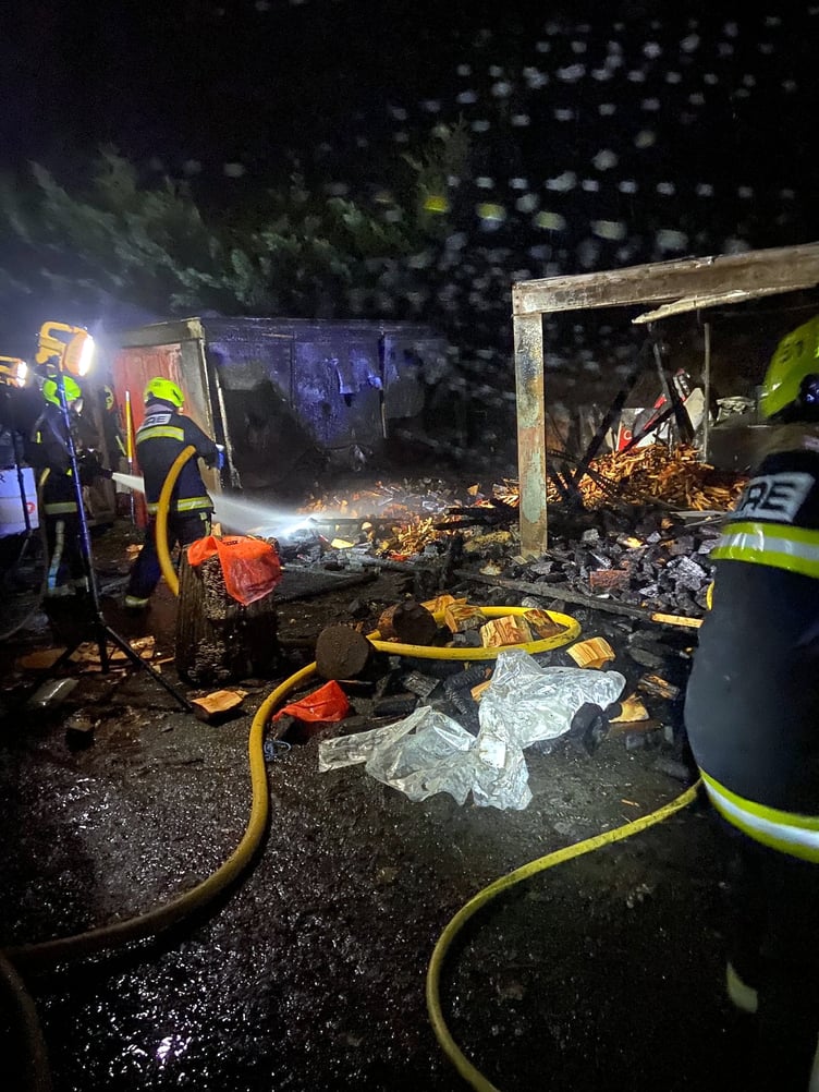 A LOG store has gone up in flames in Liverton. Firefighters from Newton Abbot and a water bowser from Danes Castle are pictured dealing with the fire. Pictures: Newton Abbot Fire Station (Dec 19 2022)