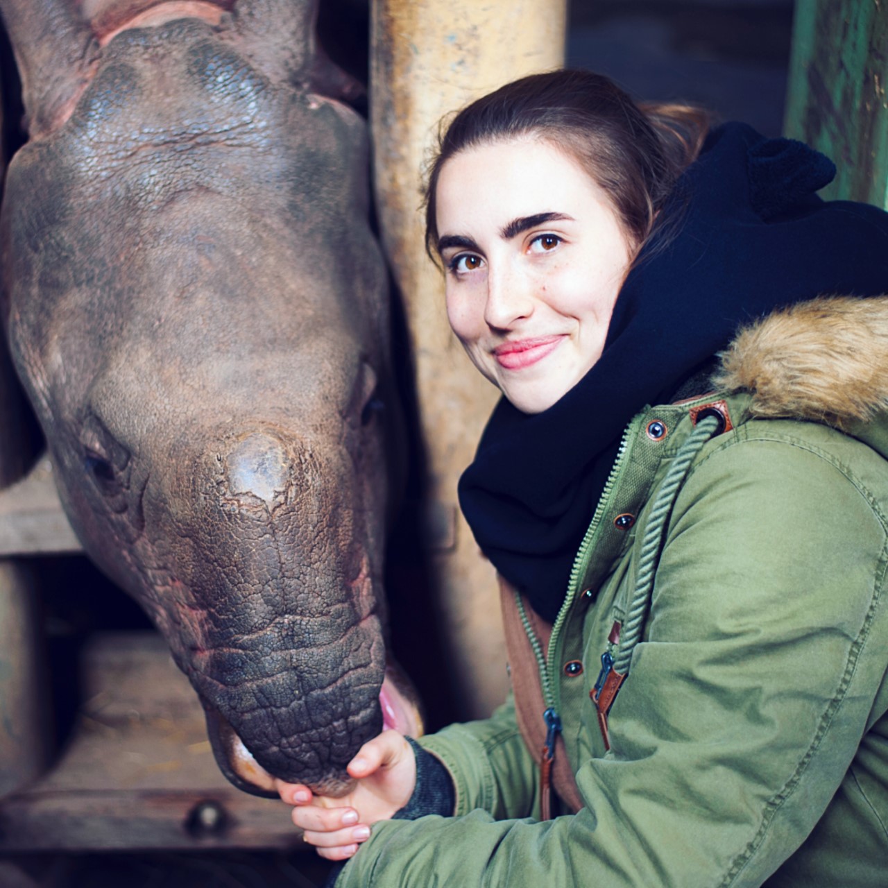 Anna Modlinska with a rhino at a zoo in the Czech Republic