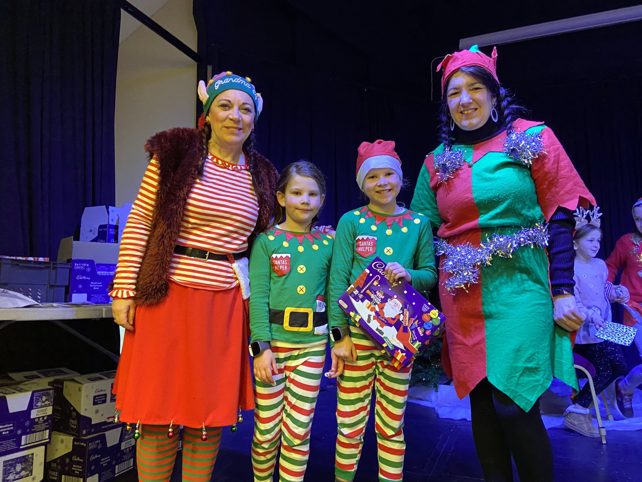 ABOVE: Greta Button as Grandma Elf alongside (left to right) Evie, Lily and Bex the Elf who all helped make the day a special event.
BELOW and BELOW LEFT: Members of the public dressed up in Christmas outfits and enjoyed a hearty cooked breakfast while giving their Christmas wishes to Santa.