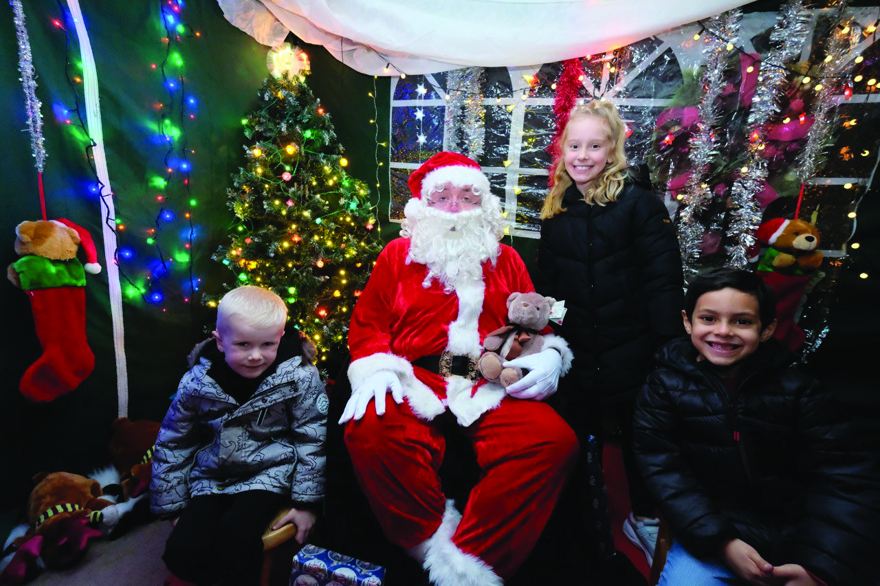 Grins in the grotto as Darcie, Xander and Harry enjoy Santa’s company.