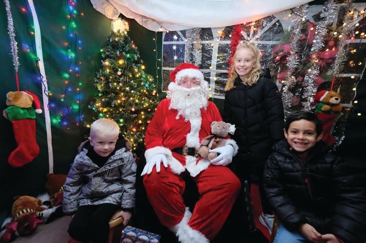 Grins in the grotto as Darcie, Xander and Harry enjoy Santa’s company.