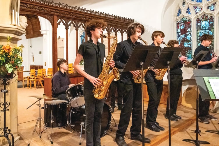 ALL THAT JAZZ – (above) The Woking High School jazz band with, left to right, Max (drums), James (tenor sax), Max and Olly (both alto sax), David (trumpet), Oscar (clarinet) and Ollie (bass guitar),get the concert swinging.