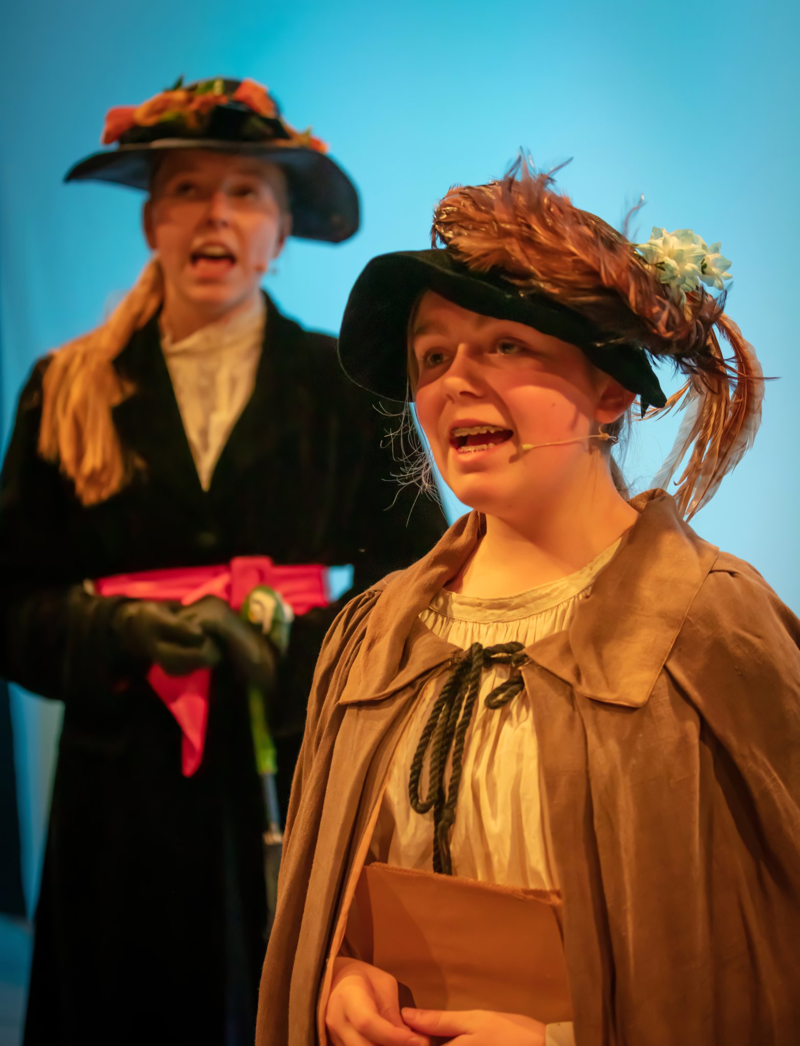 The bird woman (Matilda Spink) alongside Mary Poppins (Kate Brazendale).